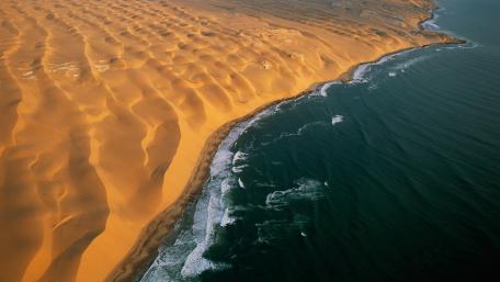 Golden Dunes Meet Azure Waves in Tranquil Harmony wallpaper