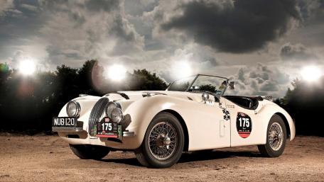 Classic Jaguar XK120 Under Stormy Skies wallpaper
