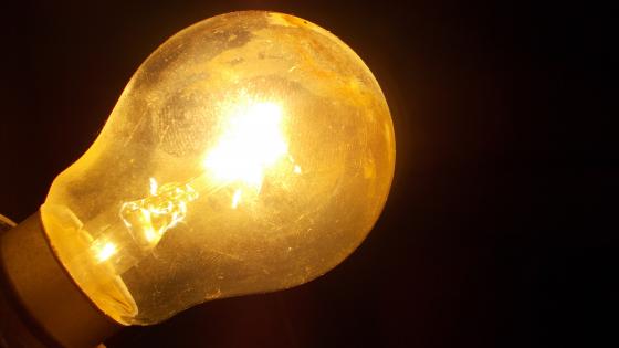 Illuminating the Darkness with a Vintage Bulb wallpaper
