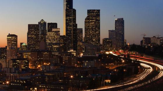 Cityscape at Dusk with Illuminated Skyline and Traffic Trails - backiee