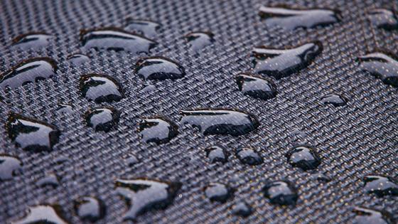 Water on textured material wallpaper