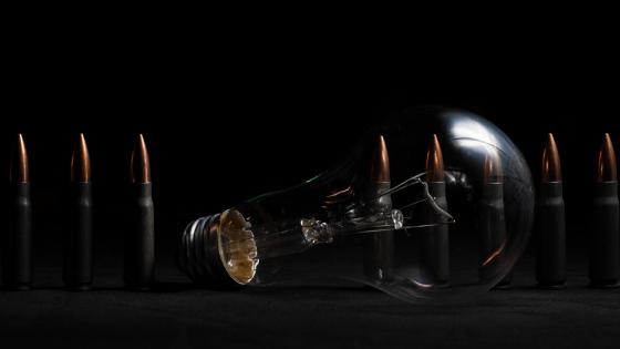 Light and Firepower Clash in Dark Imagery wallpaper