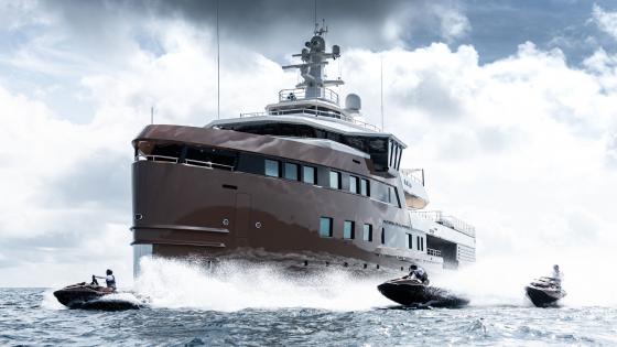 Luxurious Yacht Sailing Across Cloudy Seas wallpaper