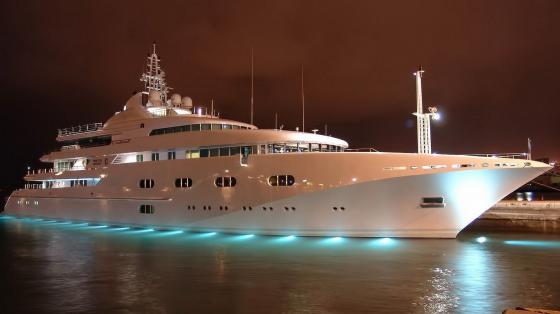 Luxurious Yacht Illuminated Against Night Sky wallpaper
