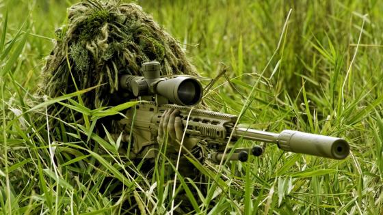 Ghillie Suit Sniper in Lush Terrain wallpaper