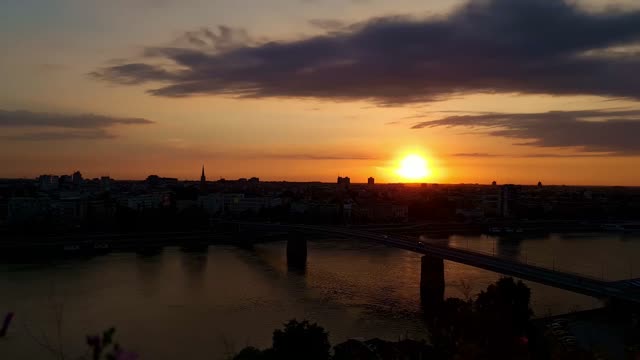 Sunset over city river bridge live wallpaper