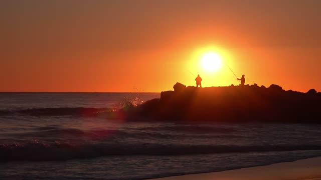 Sunset over sea with boat silhouette live wallpaper