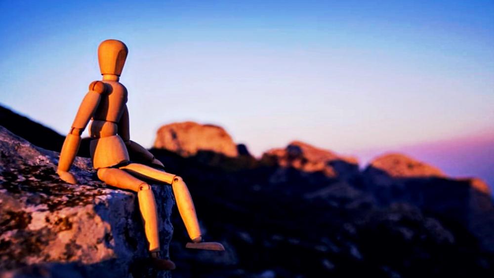 Wood puppet on the rock wallpaper