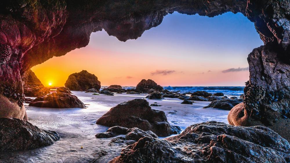 Epic sunset from a sea cave wallpaper