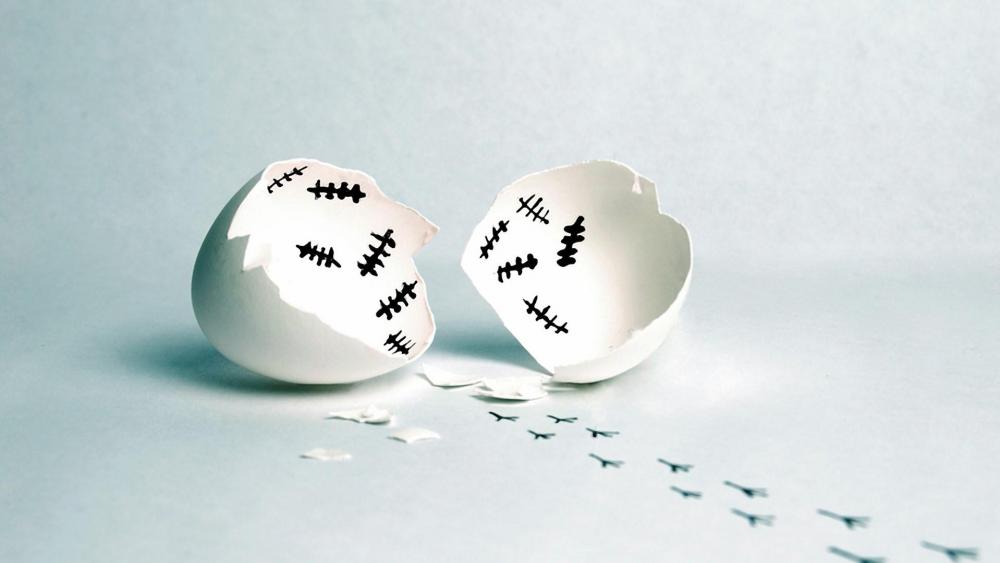 Funny egg shell with tally marks and footprints wallpaper