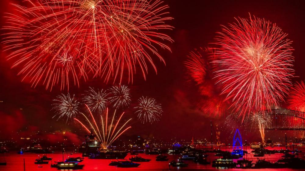 Red fireworks over the bay wallpaper
