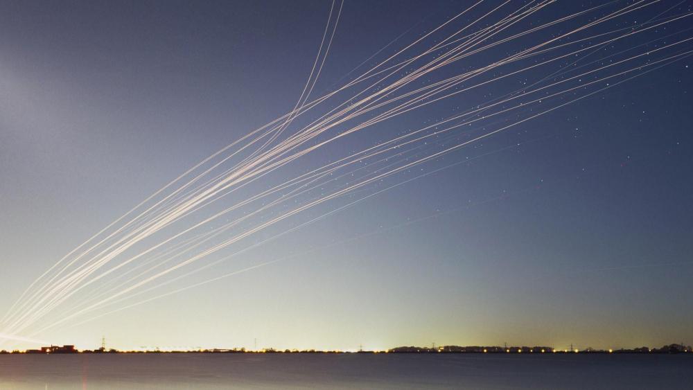 Contrails on the night sky wallpaper
