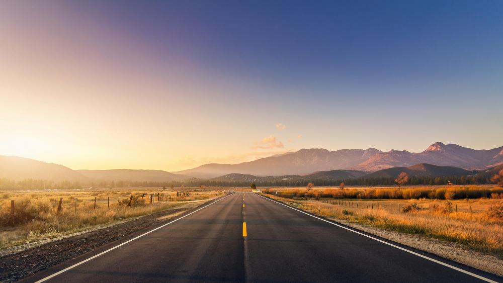 Road with sunset and mountains wallpaper