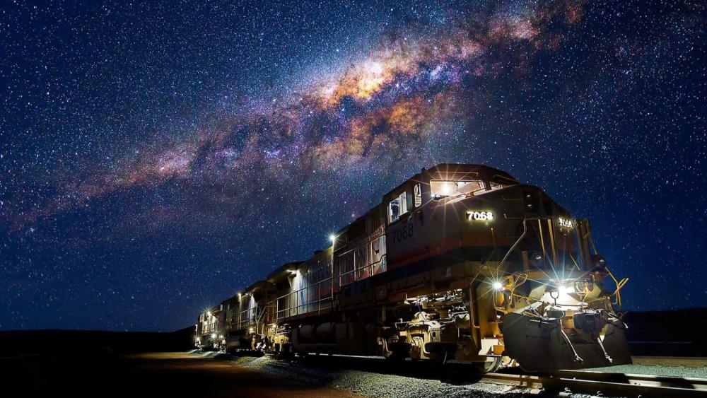 Train under the Milky Way wallpaper