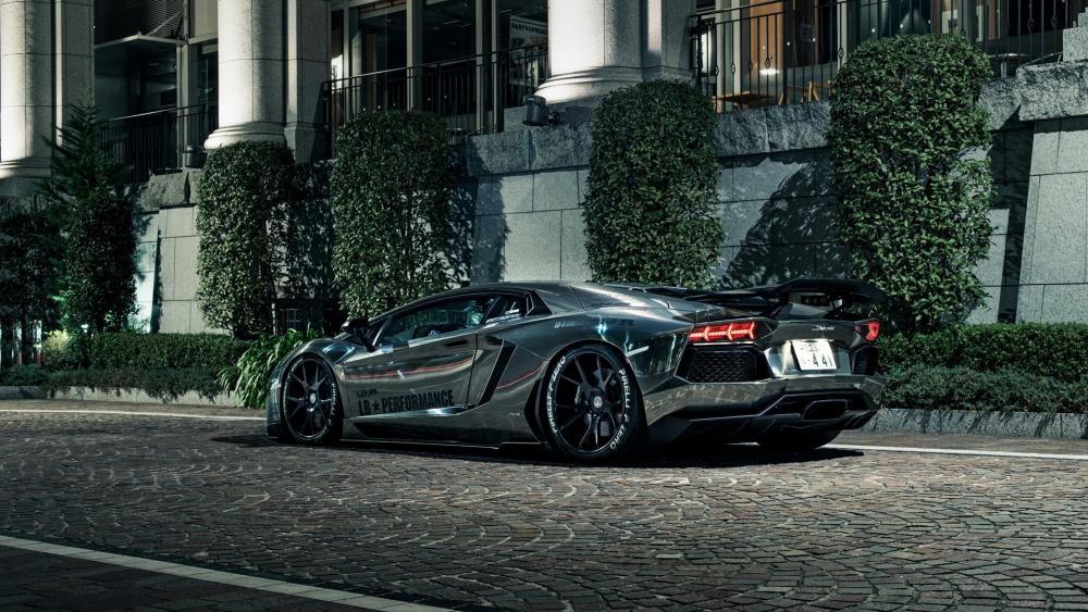 Black Lamborghini Aventador in a cobblestone road wallpaper