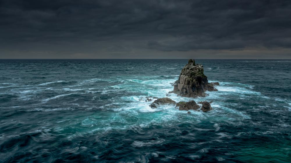 Rock islet in the ocean wallpaper