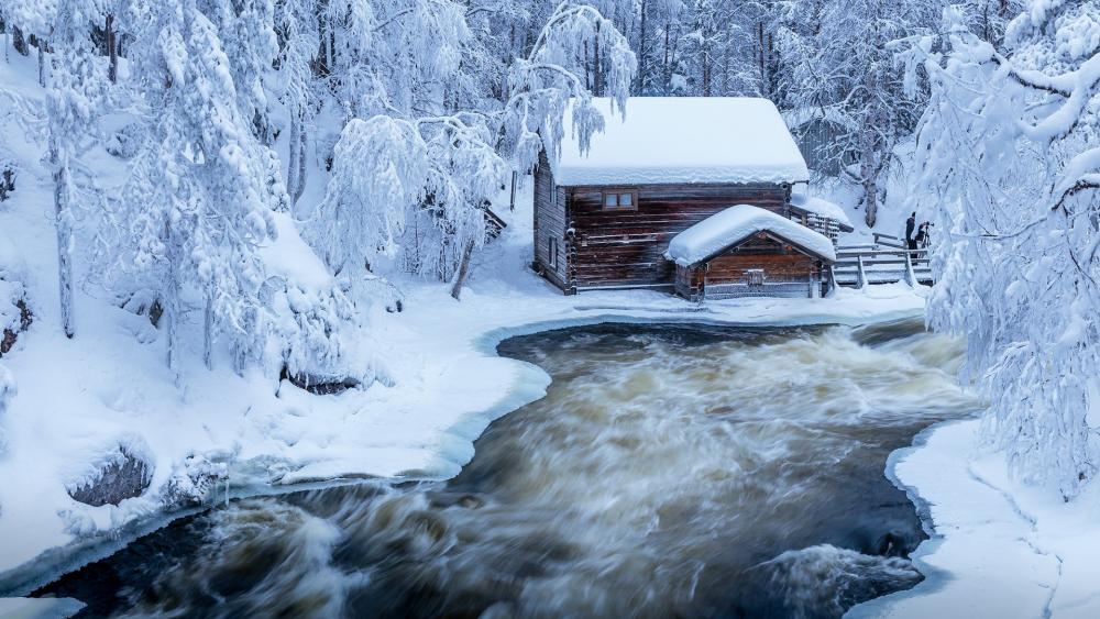 Snowy Log cabin at Kitkajoki river in Finland wallpaper