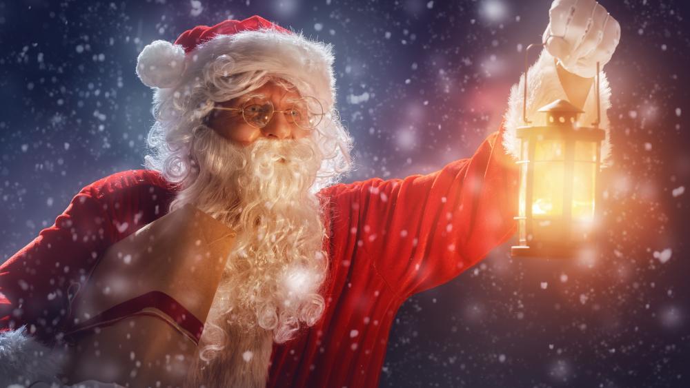 Santa Claus with a lantern in the snowfall wallpaper