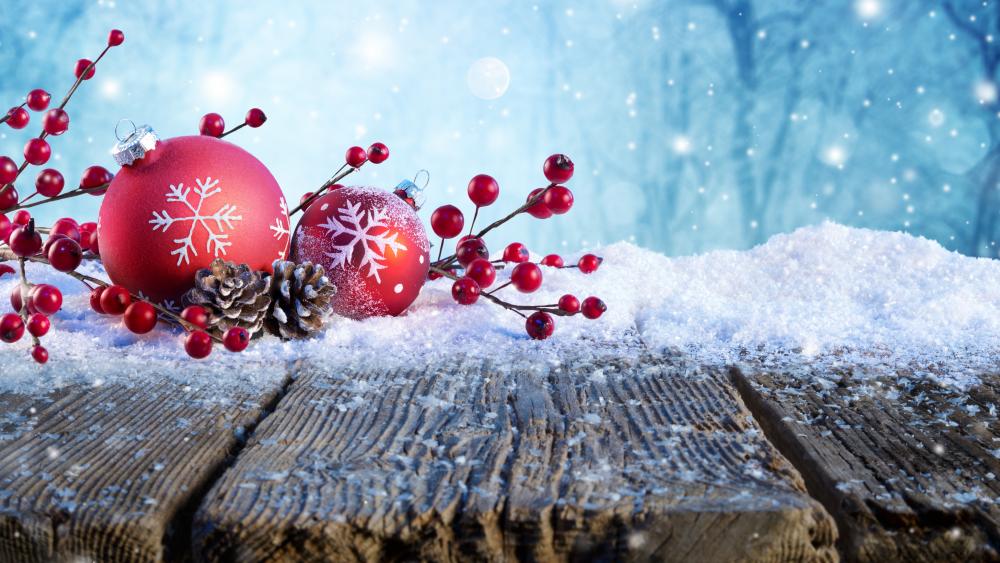 Red Christmas balls in the snow wallpaper
