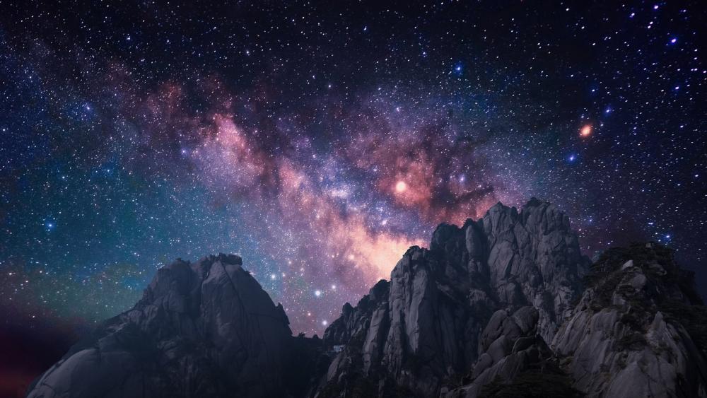 Milky way over the rugged mountains wallpaper