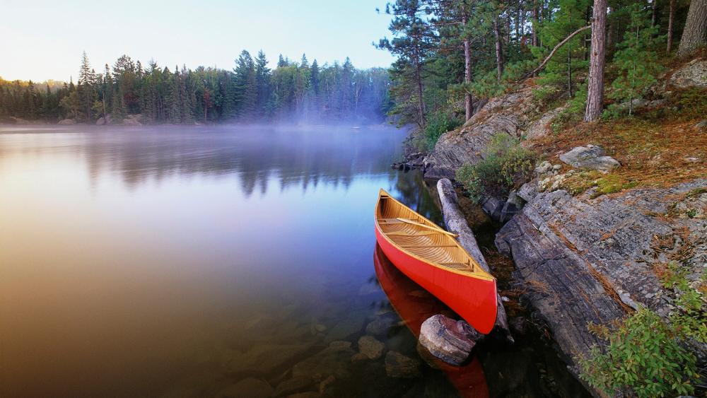 Red canoe on the misty Pinetree Lake, Algonquin Provincial Park - backiee