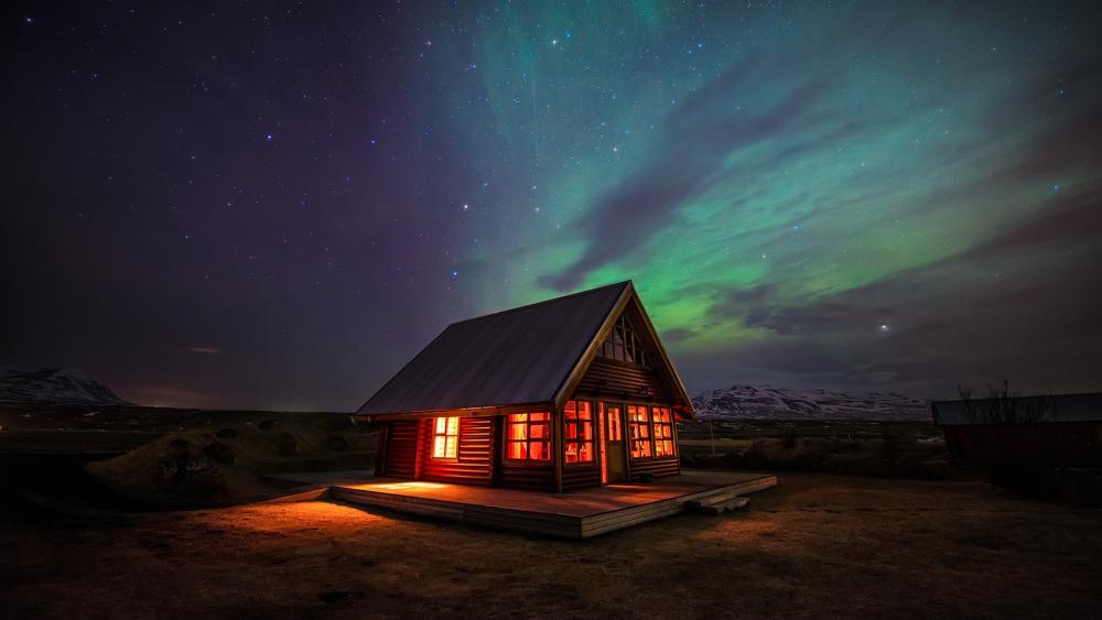 Cottage in Iceland under the polar lights wallpaper