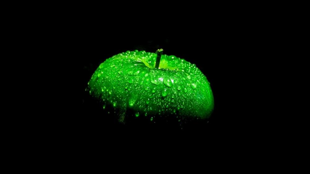 Waterdrops on a green apple wallpaper