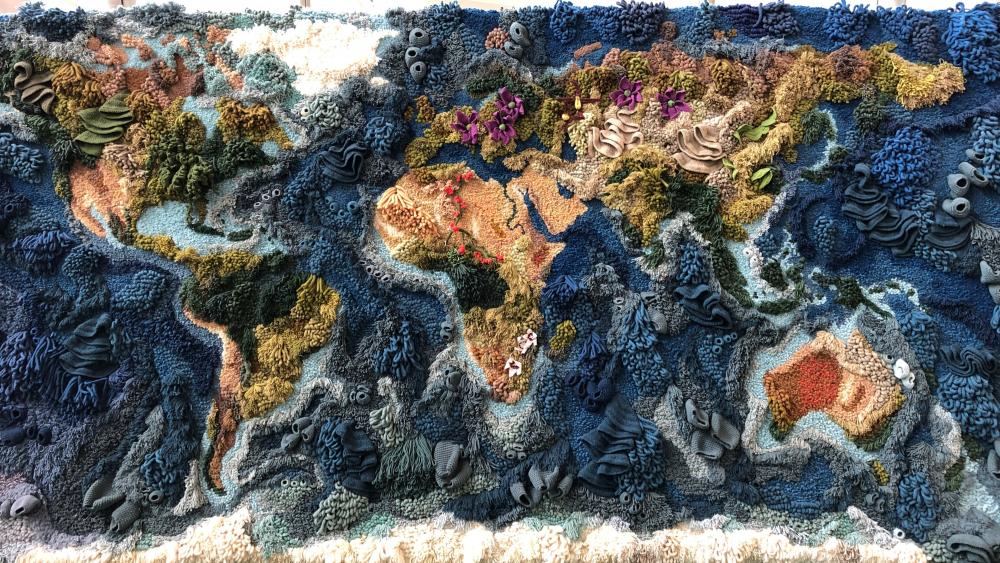 World Map made of woolen yarn at Heathrow Airport wallpaper