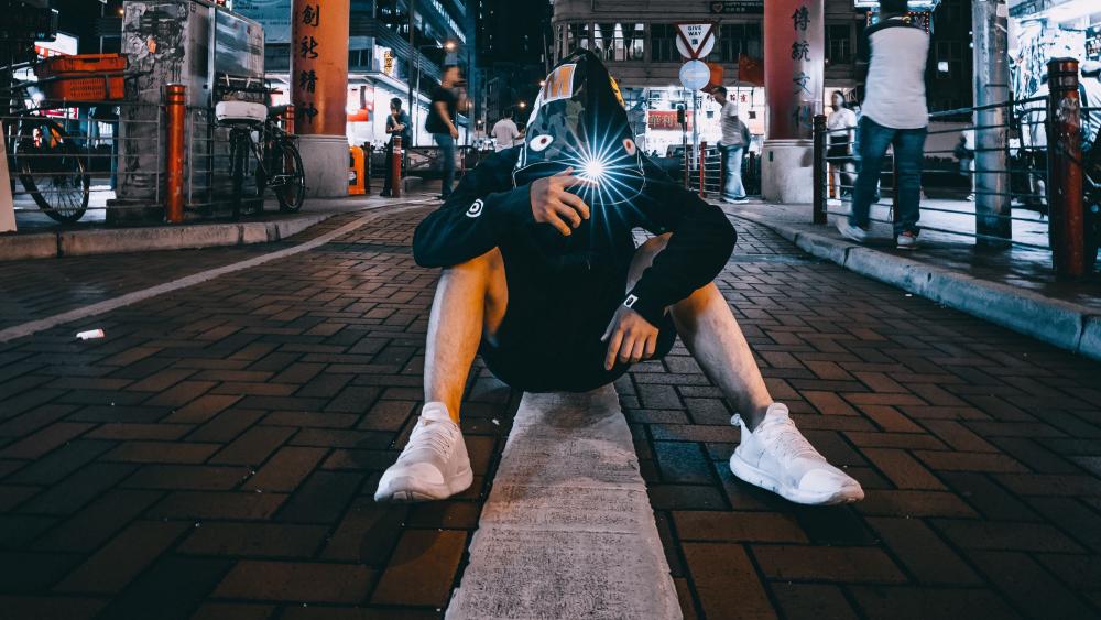 Man sitting on the street wallpaper
