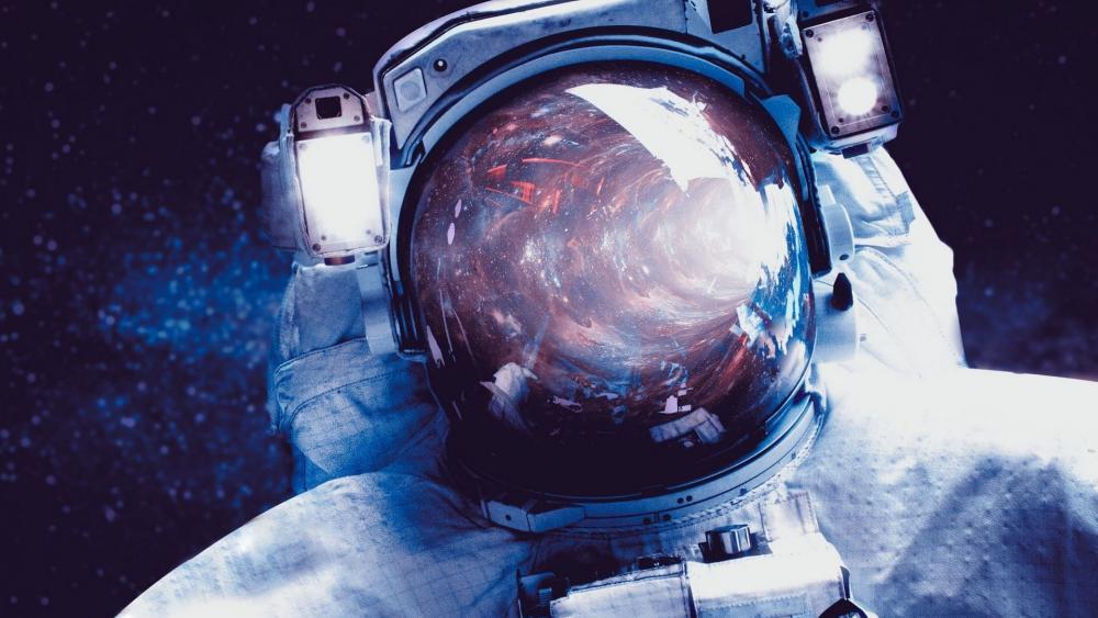 Astronaut with space reflected in helmet wallpaper