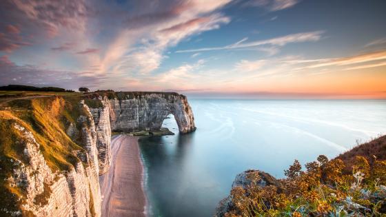 Omaha beach in normandy, france. Perfect clean sand with rotten breakwater  wood. Beach wallpaper. Stormy sky Stock Photo | Adobe Stock