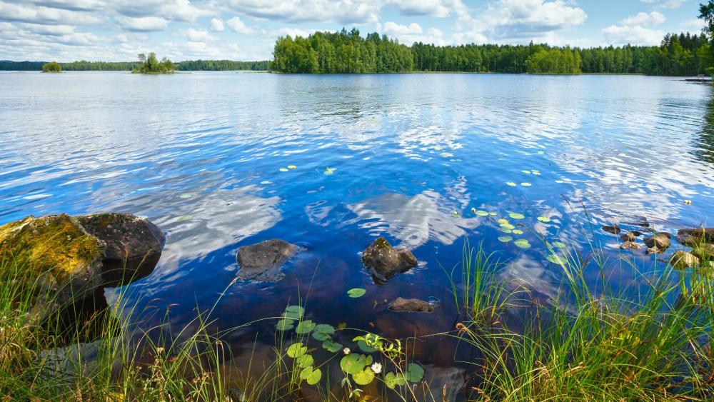 Lake Rutajarvi summer view with reflection of clouds on water surface (Urjala, Finland) wallpaper
