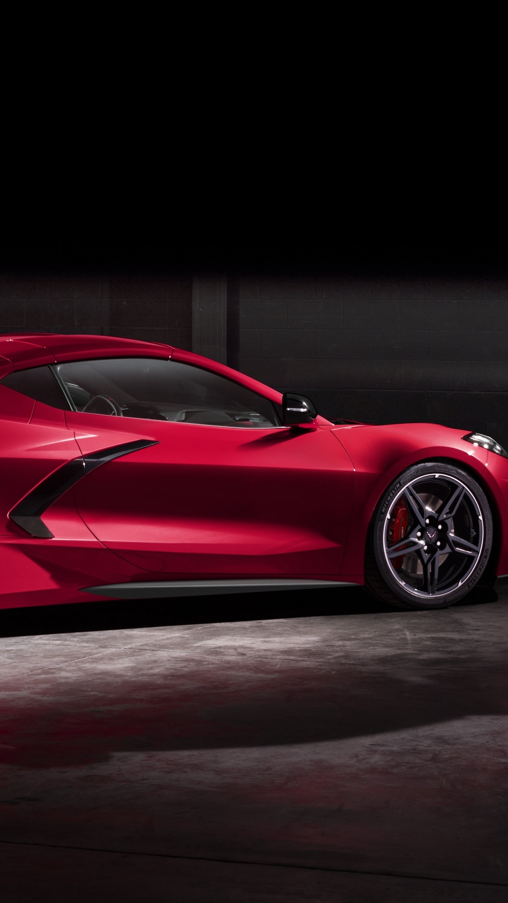 Sleek Red Chevrolet Corvette Stingray Sports Car in Shadowy Ambiance ...